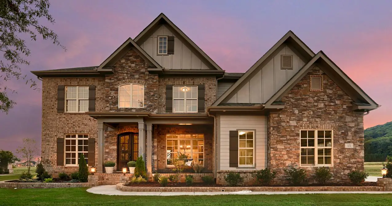 A large brick home with a lot of windows.