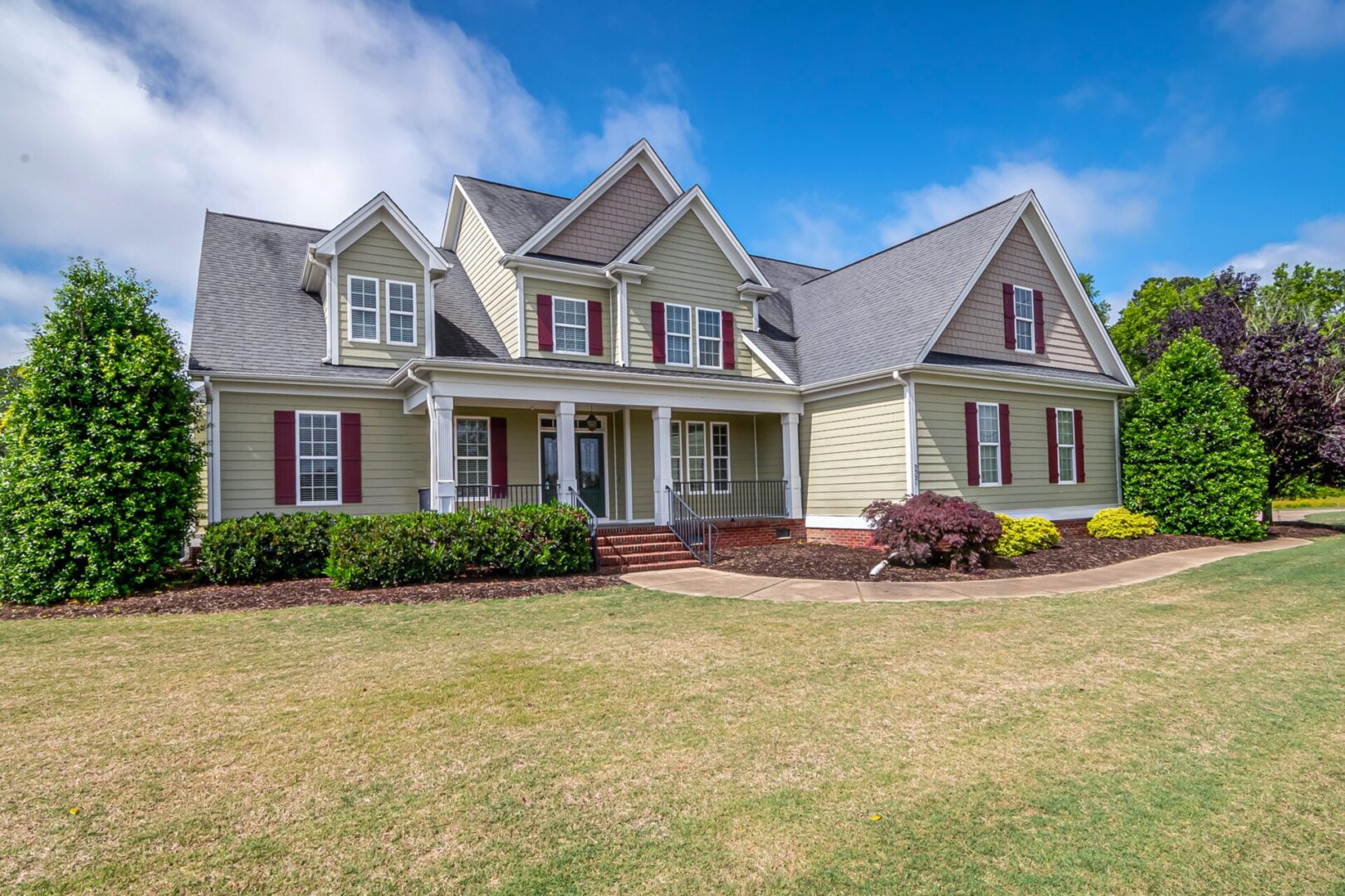 A large house with a lawn in front of it.